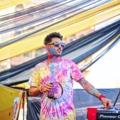 A candid shot of me at the decks during a Holi celebration. I'm ready to spin tracks that match the vibrant and joyful energy of the festival of colors.