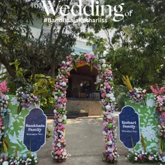 A beautiful floral archway serves as the main entrance to the wedding, with signs welcoming the two families. It's a warm gesture that symbolizes the union of not just the couple, but their loved ones as well.
