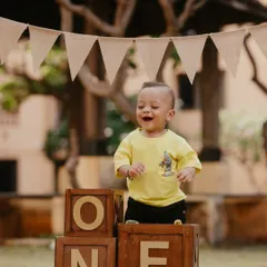 That "I'm one!" feeling. This little boy's infectious giggle is the centerpiece of this outdoor first birthday shoot.