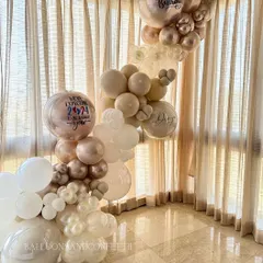 A closer look at the personalized details. We can add custom text to balloons, like the "We're expecting 2024 to be a great year" message for this baby announcement.