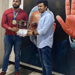 Celebrating success is part of our culture. Here, our champion athlete is being recognized for his hard work and achievement, showcasing the supportive network we build around our members.