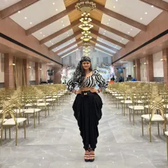 A bold, symmetrical shot in a striking fusion outfit. The zebra-print top and dhoti pants create a powerful, modern-ethnic look perfect for a fashion editorial.