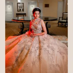 The bride looks like a modern-day princess in her stunning silver-embroidered ball gown. This portrait captures her elegance and poise in a quiet moment before the reception festivities begin.