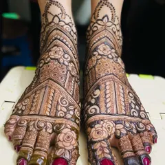 My bridal services include detailed and elegant mehendi for feet, ensuring you are adorned from head to toe. This design features intricate floral and architectural patterns covering the entire foot.