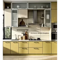 This L-shaped kitchen uses a cheerful yellow and off-white color scheme. The layout includes integrated appliances and a mix of drawers and cabinets for versatile storage.