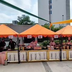 Our vibrant food stalls are perfect for outdoor festivals and corporate fun days. Here, our chefs are ready to serve a variety of delicious options under colorful canopies, adding a lively and casual feel to the event.