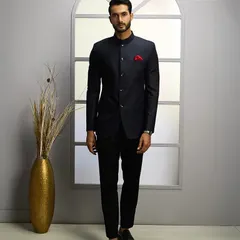 A modern interpretation of classic Indian formal wear. This bespoke navy Jodhpuri suit features a sharp mandarin collar and a clean, structured fit, perfect for weddings and distinguished celebrations.