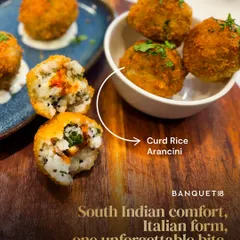 This is our Curd Rice Arancini. We took a beloved South Indian comfort food and gave it an Italian twist, creating a crisp, creamy appetizer with a surprise burst of mango pickle inside. It’s a perfect example of how we love to blend the familiar with the unexpected.