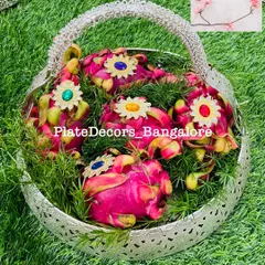 A beautiful silver basket filled with decorated dragon fruits. This is a great way to present exotic fruits as part of the seer varisai.