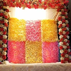 A closer look at the textured floral backdrop for the Ganpati mandap. The mix of colors and flowers creates a rich and festive look.