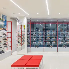 The interior of the Paragon showroom, where we used a clean, bright layout with pops of the brand's signature red. The design focuses on clear zoning and organized displays to enhance the customer shopping experience.