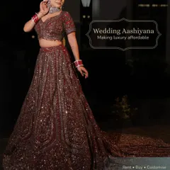 A full-length view of a timeless bridal lehenga with a long, flowing trail. This piece is designed for a regal look, perfect for your wedding ceremony photos.