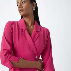 A sleek and modern look for a Westside blazer dress. The makeup is clean with a defined lip, and the hair is pulled back to create a sharp, professional silhouette.