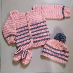 I love creating complete, coordinated outfits. This cozy winter set includes a striped cardigan with wooden buttons, a matching pom-pom beanie, and a pair of adorable booties, all handmade to keep your baby warm and stylish.