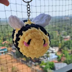 This fluffy bee keychain is made with super soft plushie yarn, making it extra cuddly. The cheerful expression and tiny wings make it an adorable accessory for any bee lover.