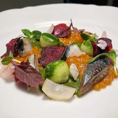Torched mackerel with escabeche, wasabi watercress, and compressed cucumbers. The smokiness of the fish is balanced by the sharp, fresh flavors of the vegetables.
