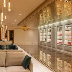 The experience center we designed for a premium chocolate brand exudes sheer grace and luxury. The long, gallery-like space features a reflective gold ceiling, plush seating, and beautifully lit display cabinets to showcase the products like jewels.
