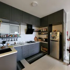 This kitchen is so smooth, even my cooking disasters might start looking gourmet. A modern, moody grey kitchen with open spice racks and a clean, organized feel.
