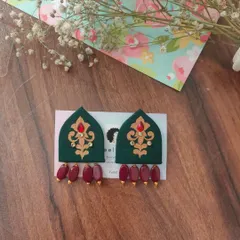I love the royal look of these hand-painted earrings. The dark green fabric is shaped like a traditional arch and adorned with red and gold details, with dangling red beads.