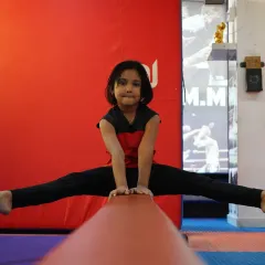 Balance, focus, and confidence on full display. Our gymnastics program helps children develop exceptional strength and flexibility, and this young athlete demonstrates the amazing results of her dedication on the balance beam.
