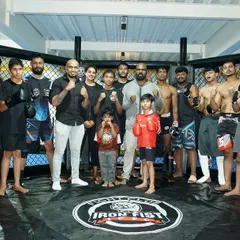 The Iron Fist family. This group photo inside the octagon shows the diversity of our club, with men, women, and children all training together as one team.