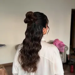 This side-back angle shows the texture and volume of the half-up style. It's a modern and chic choice for influencers, bridesmaids, or wedding guests.