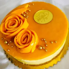 This mango cheesecake is a tribute to Mom, decorated with rosettes made from fresh mango slices and a "Happy Mother's Day" topper. It's as beautiful as it is delicious.