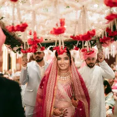 The bride's grand entrance under a beautiful 'phoolon ki chadar', a truly magical moment.
