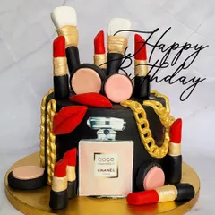 A badass, all-black cake for a makeup lover. This Chanel-themed cake is adorned with edible lipsticks, makeup brushes, and a Coco Chanel perfume bottle.