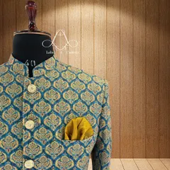 A closer look at the teal and gold brocade Bandhgala. You can see the texture of the fabric and the detail in the woven pattern. I source high-quality materials to ensure every garment not only looks good but feels luxurious.