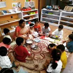Children gathered together to prepare a traditional sweet for Diwali. Group activities like this foster a sense of community and cooperation, as they all contribute to creating something special for the celebration.
