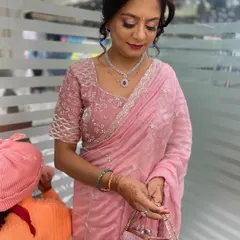 This client is ready for a special event with her elegant updo and professional makeup. We created a soft, romantic hairstyle that complements her beautiful saree and jewelry.