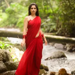 We went outdoors to capture this shot, using the soft, natural light of the woods to complement the vibrant red saree. This is an example of an environmental portrait where the subject and the setting tell a story together.