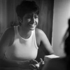 A joyful and candid black and white portrait of a woman with a wide, genuine smile, captured in conversation. This image highlights my ability to capture authentic personality and emotion.