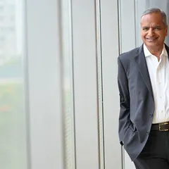 A relaxed portrait of a corporate leader taken on-location. The natural light and office background create a professional yet unstaged feel.