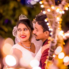A candid moment captured through a curtain of bokeh lights. This technique adds depth and a dreamy quality, making the couple the shining focus of the photograph.