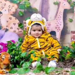 Welcome to the jungle! This adorable baby is dressed as a tiger in our fun and colorful jungle safari set.