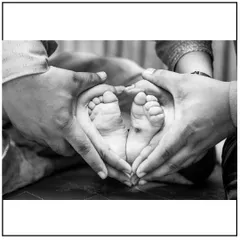 The tiny details are the ones you'll want to remember most. This classic black and white shot of a newborn's feet held by their parents is a perfect example of the detail-oriented newborn photography I offer.