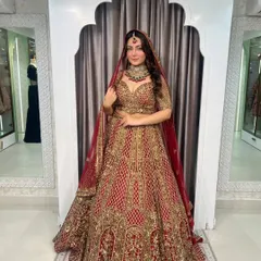 A full-length view of this stunning red and gold bridal lehenga. Notice the intricate hand embroidery and the grand flare, designed to make you feel like a queen.