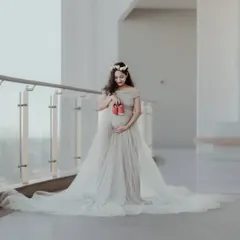 Maternity shoots are about celebrating the journey to motherhood. Here, I used soft, natural light and a flowing gown to create an angelic and serene portrait, with the tiny shoes hinting at the joy to come.