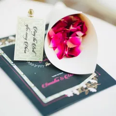 We love making guests part of the ceremony. This little card instructs them to "Ring the Bell after every Phera," and is paired with a cone of fresh rose petals for the celebration.