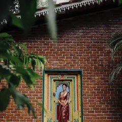 A stunning bridal portrait framed by a colorful, ornate doorway against a rustic brick wall. This composition creates a beautiful contrast, making the bride and her attire stand out.