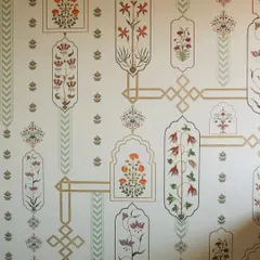 This wallpaper design is a direct homage to the intricate floral patterns found in Mughal architecture. Each motif is carefully placed within geometric frames, creating a sophisticated and rhythmic pattern that speaks of timeless elegance.