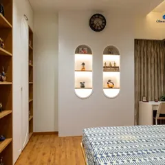 We add personalized touches to every room. These custom-built arched wall niches with integrated lighting provide the perfect display space for cherished decor items, adding character and warmth to the bedroom.