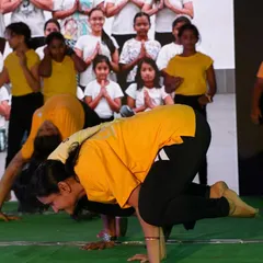 Students demonstrate their mastery of Bakasana (Crow Pose) during a public performance.