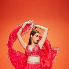 This dynamic shot captures the energy of a celebration. The makeup features a dramatic red eye that is blended to perfection, creating a powerful and confident look that’s ideal for a cocktail night or sangeet performance.