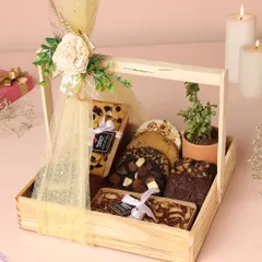 Gifting should feel special, and my festive hampers are designed to do just that. This wooden basket hamper is filled with my best-selling brownies, cookies, and a plant for a touch of green, perfect for Diwali or any celebration.