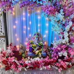 Our cherry blossom theme is a favorite for its delicate and modern look. Here, we have created a beautiful arch with pink, white, and red artificial cherry blossoms, complemented by a soft white curtain backdrop with fairy lights for a magical glow.