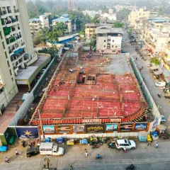 An angled drone shot capturing the construction progress from a different viewpoint. We provide multiple angles to give a complete picture of the site's development and surrounding infrastructure.