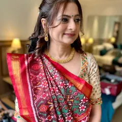 Traditional charm with a modern glow. This soft yet striking makeup enhances her natural beauty, perfect for the mother of the bride.